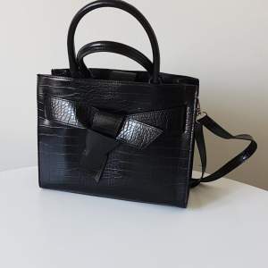 Black croc bag from Accent with a bow
