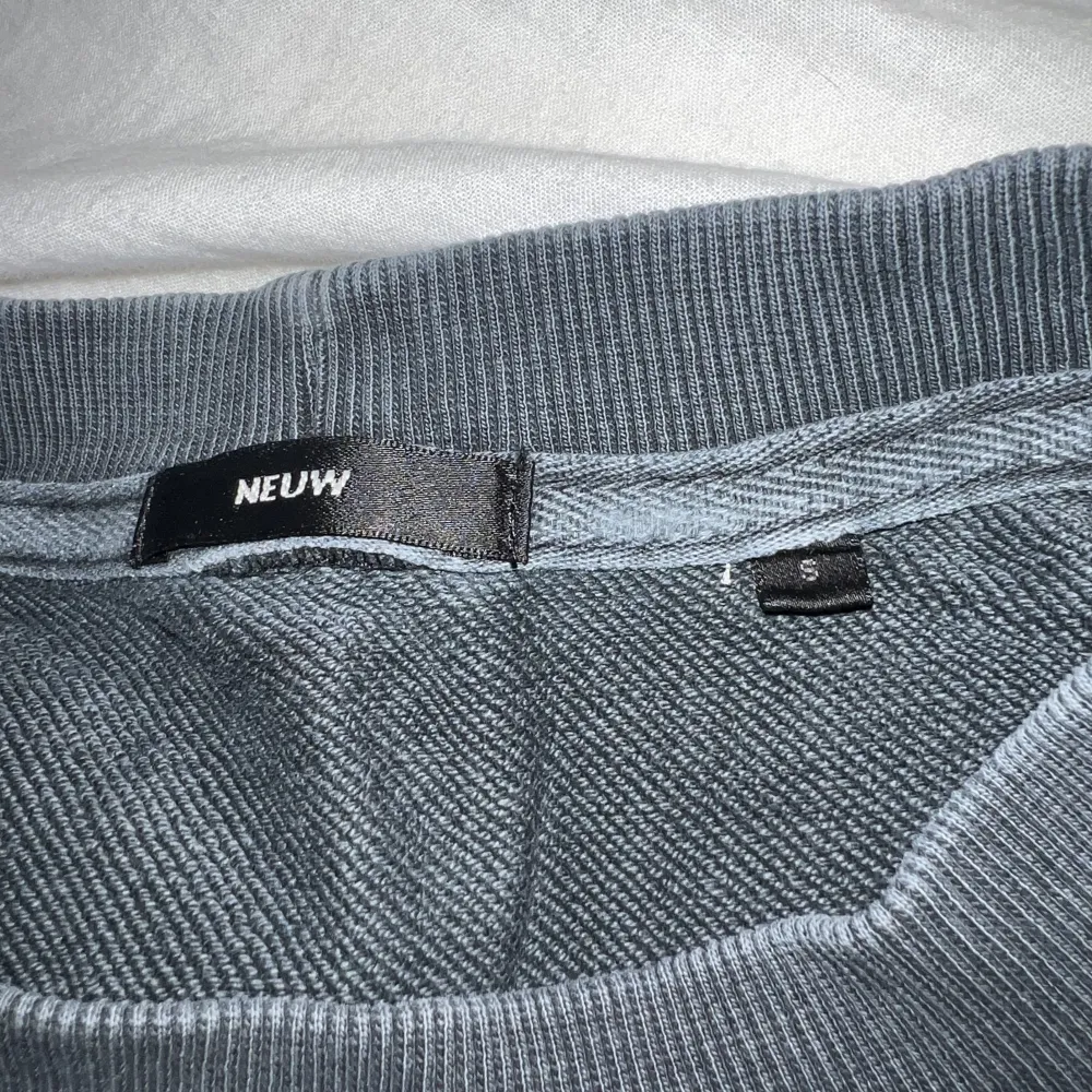 Riktigt snygg Neuw Stockholm tröja Bra skick inga defekter eller liknade använd ett fåtal gånger köpt för cirka 1000 kr Grå/svart ska vara ojämn i färgen . Hoodies.