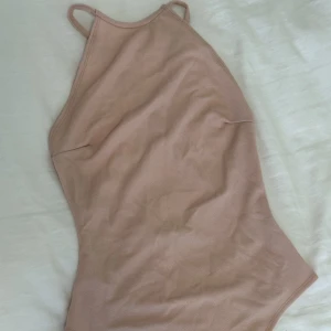 Body - Ljusrosa body, använd en gång.