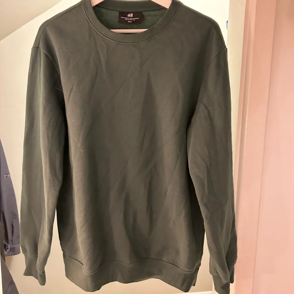 En grön sweatshirt från H&M i storlek S. Färgen blir missvisad i andra bilden, första bilden visar hur färgen ser ut! 😄. Hoodies.