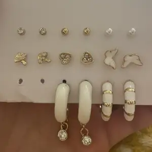 Different earrings between hoops, pearls and studs. Not worn.
