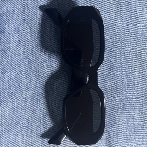 Prada Symbole solglasögon  - Äkta. Aldrig använda. Väldigt snygga men passar tyvärr inte mig. Tillhörande box och skydd medföljer. Storlek: 49 MM 