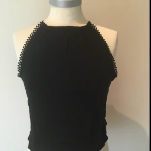 Svart topp - Ett svart linne med detaljer längst sidorna har ett likadant i vitt på min profil också :)