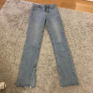 Ett par blåa slit jeans från GinaTricot. Jeansen är högmidjade och ganska raka upptill. Nedtill går de ut lite och har en fin slits❤️