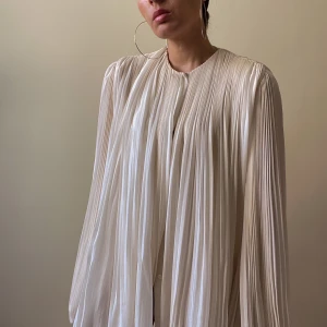 Preloved Nina Ricci Silk Chiffon Blouse - Nina Ricci Boutique cream silk chiffon pleated top   balloon sleeves with elastic cuffs, discreet button closure. Fabric is sheer and flowy with lining Minor stain by the 3rd top button, not visible when worn. Very Good Condition  Size between S-L