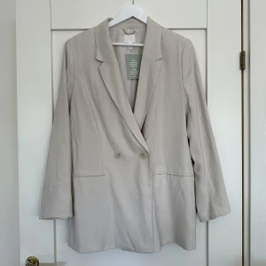Beige kavaj - Beige kavaj från H&M, köpte förra hösten men aldrig använt. Nyskick!