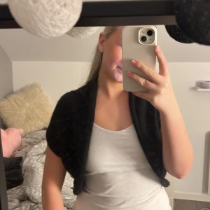 Svart bolero - Säljer en svart bolero med en hint av glitter i sig. Knappt använd. Är från H&M men från en mycket gammal kollektion. Är i storlek M men skulle säga att den är ganska förlåtande om man är mindre eller större än det💓