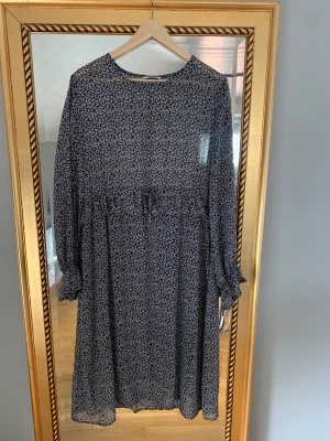 Blommig klänning - Klänning från Ellos. Skirt tyg upptill. Bra skick. 