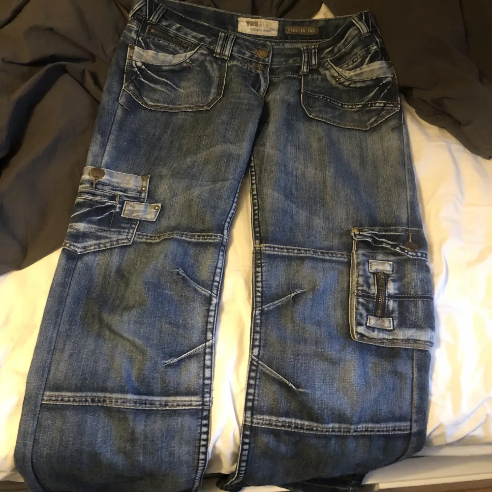 supercoola och unika straight leg jeans i blått. De sitter lowwaisted och är i storlek 42 :) De har dragkedjor, fickor och patches! Pris kan diskuteras. Jeans & Byxor.