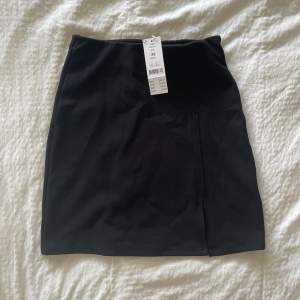 Svart tight kjol från Gina tricot. Storlek XS. Aldrig använd, prislappen är kvar.