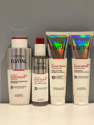 L'Oréal Elvital Bond Repair set - Säljer ett set med L'Oréal Paris Elvital Bond Repair produkter: schampo, leave-in serum och två balsam. Förpackningarna är i silver och vitt med holografiska detaljer och röda inslag. Passar alla hårtyper och är framtagna för skadat hår.