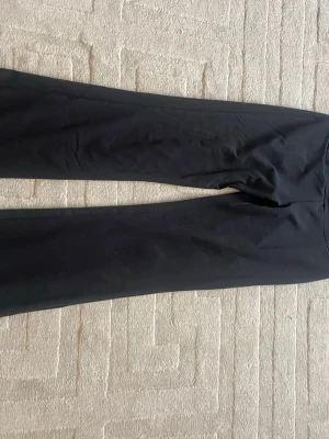 Svarta leggings från OTP, storlek M - Säljer ett par svarta leggings från OTP i storlek M (40/42). De har en klassisk, tight passform och är tillverkade i ett stretchigt material som sitter skönt på kroppen. Perfekta till både träning och chill. Snygg och enkel design utan detaljer.