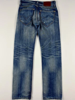 Levi’s 601 Straight Jeans Blå W30 L32 - Vintage Slitna Denim - Levi’s 601 Vintage Jeans med snygga detaljer & slitningar.  Färg: Blå med ljusa tvättar, fades & slitningar  Passform: Straight  Storlek: W30 L32 Skick:  B Grade Mått [platt] (±1 cm): A: 38 cm B: 104 cm C: 27 cm D: 20 cm OBS: Jeansen passar inte på killen i bilden!  Tveka inte att höra av dig vid frågor eller funderingar.  Skickas snabbt!