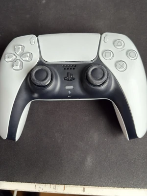 Vit och svart PS5 DualSense handkontroll - DualSense handkontroll till PS5 i vit och svart design. Ergonomisk form med två analoga spakar, touchpad och klassiska PlayStation-knappar. Tillverkad i plast med matt finish och detaljerad knappuppsättning för maximal spelkänsla., har stickdrift dock