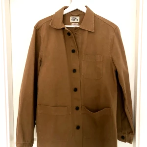 Jacka - Brun/beige jacka. Perfekt till våren som är Påväg nu. Passar allt från en med Xs- M beroende på önskad passform.