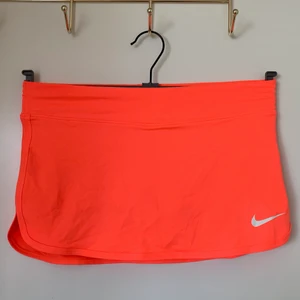 Orange-rosa nike tenniskjol - Orange-pink nike tennisskirt, size XS. Tight och kort tenniskjol med shorts under. 