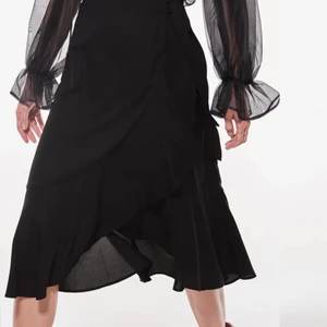 Svart omlottkjol från Gina Tricot  - Jättefin svart omlottkjol med volanger från Gina Tricot, perfekt nu till sommar och vår! Använd endast en gång då den är för liten för mig! Storlek 34! Köpt för 299kr säljer för 100kr+frakt eller kom med eget bud som du tycker känns rimligt då pris är diskuterbart😊