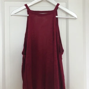 Vinrött linne  - Vinrött linne med djup urringning vid ryggen. Storlek M