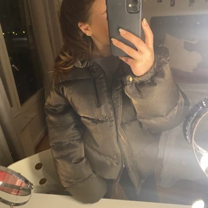 Moncler jacka  - Säljer min mammas gamla moncler jacka. Den är i storlek (3) men skulle säga att den passar M. Om det hjälper har jag på bilden vanligtvis xs/s. Jackan är i brun/guldig färg och väldigt puffig. Äkthets bevis finns tyvärr inte men den är äkta,  Den går inte att få tag på så den är väldigt unik. Den är i finschick då den är hel med inga skador. Den har även band som man kan spänna längst ner på jackan. Fråga gärna om ni undrar något💕
