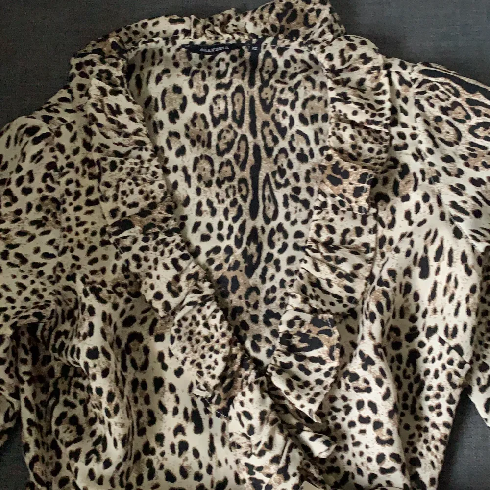 V-ringad volang leopard klänning, supersöt och bekväm, söm i midjan som skapat form med hjälp av bältet . Klänningar.