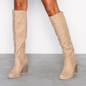 Oanvända beiga mockastövlar  - Säljer dessa snygga knähöga stövlar från Nelly på grund av att jag har liknande och dessa inte kommit till användning. Passar alla årstider! 