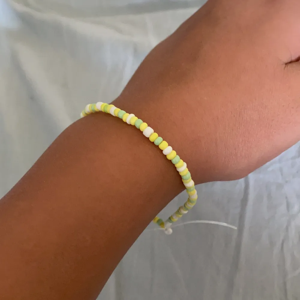Fint armband med gult grönt å vittt mönster ❤️. Accessoarer.