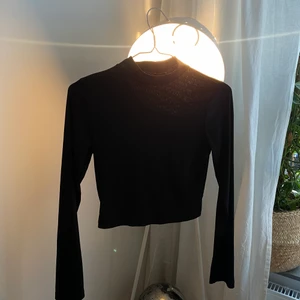 Croppad svart långärmad  - En svart croppad topp som är lite ribbad i tyget. Har användts varsamt & den passar superbra till alla tillfällen. Storlek S! ❤️❤️❤️🌸🌸🌸🌸 säljs för 40 kr köparen står för frakt