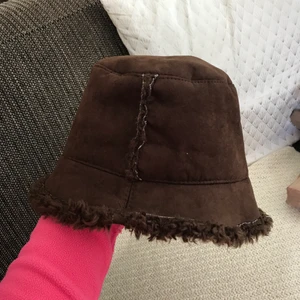Bucket hat i päls - En typisk Y2K bucket hat i brun mocka och päls inuti (fake päls såklart!) 🧡✨ Skitcool, storlek M typ och snygg på både vintern o sommaren! Superfint skick, köpt secondhand men aldrig använd av mig 💕