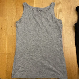 Ett grått linne, storlek 134/140 - Samma linne som den svarta. Från kappahl i storlek 134/140. Använd 1 gång för ett jätte långt tag sen.