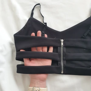 Topp - Svart topp. Riktigt snygg! Dragkedja i ryggen och justerbara band 