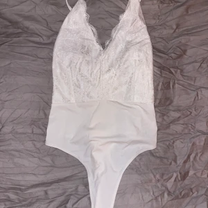 Vit spetsbody  - En vit spets body, öppen med kryss i ryggen och string bak!