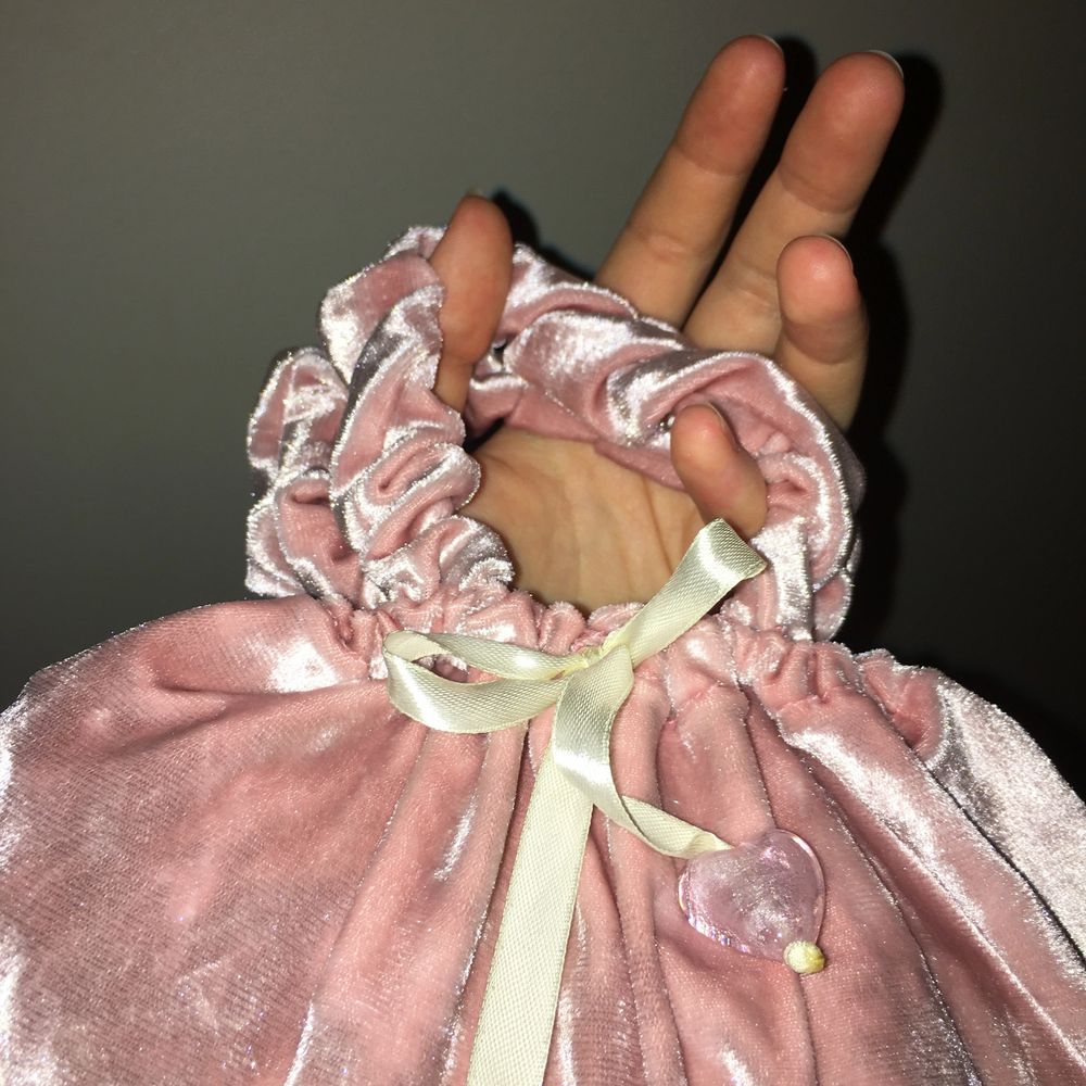 Supersöt liten handväska i återanvänt velourtyg. Väskan är hemmasydd. Handtagen är lite elastiska såsom scrunchies och väskan försluts med ett satinband med hjärtan av glas. Väskan är rymlig och anpassar formen efter innehållet. Önskas mer information ov väskan är du välkommen att kontakta mig. . Väskor.