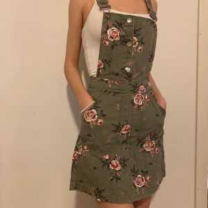 H&M blommig jeans klänning  - Hej 👋🏼 blommig klänning som jag måste sälja med krossad hjärta, blivit för liten för mig. Storlek 32 och liten 34,  i magen (59-61 cm). Lägsta bud: 70