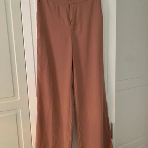 Hannalicious X Na-Kd kostymbyxa - Hannalicious X NAKD kostymbyxa i beige/rosa färg. Storlek 38/medium. Passformen är relativt thight kring midja och rumpa och blir sen flare. Skickas eller hämtas i centrala Linköping, betalning sker innan jag skickar! 