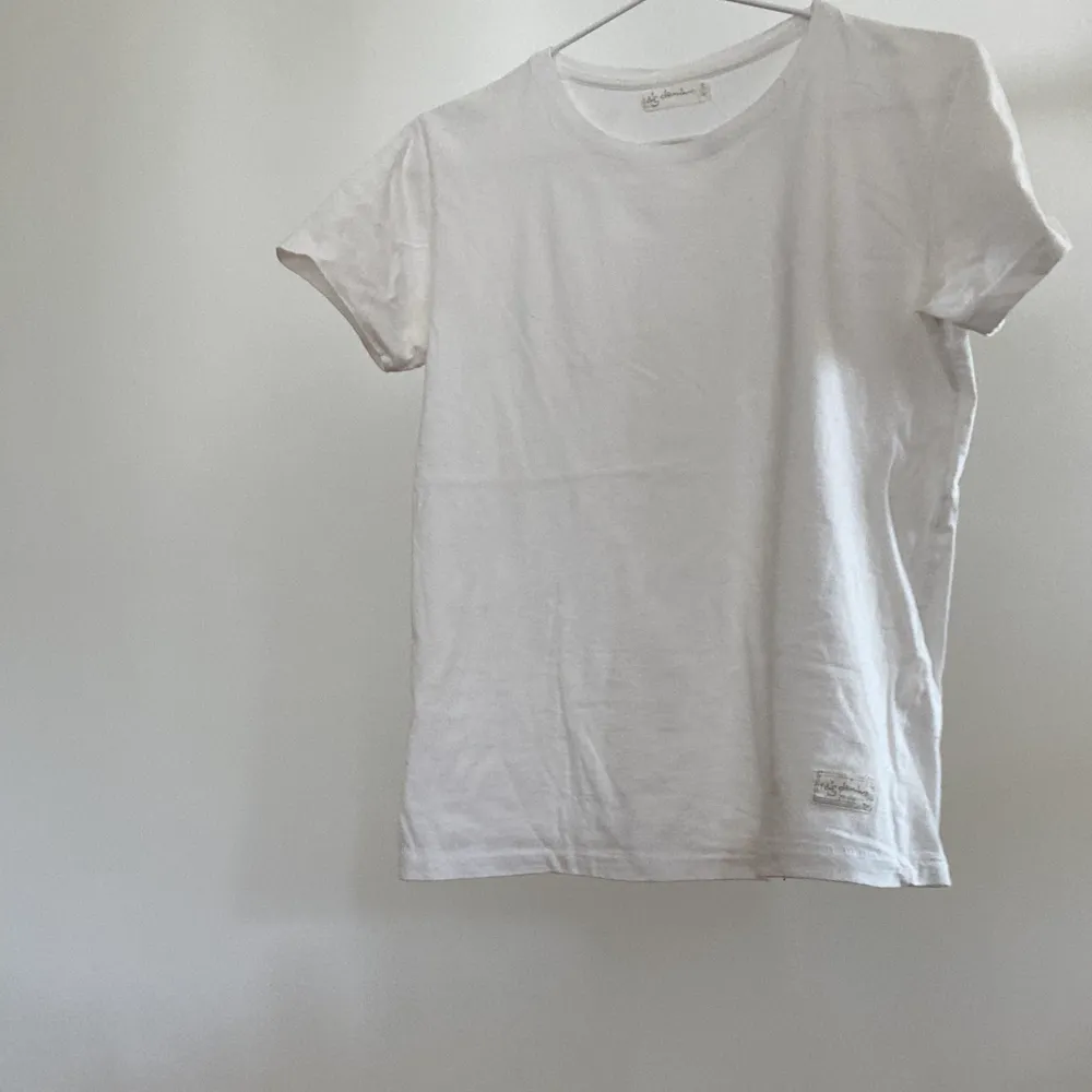 En vit enkel t-shirt av märket I Dig Denim. I nyskick, ej gulnad eller liknande. Väldigt plan och lätt att styla. Tveka inte att kontakta mig vid frågor!. T-shirts.
