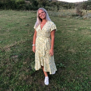 Gul blommig klänning  - En fin gul klänning i omlott, köpt på ginatricot💛