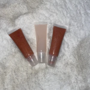 Läppglans  - Säljer 2 st rosa/nude läppglans med skimmer och ett ofärgat läppglans. De innehåller ricinolja och bio olja vilket ger dem en läkande och mjukgörande effekt. Passar bra om du har ärr eller märken från gamla sår på läpparna då dessa läppglans gör så att de fadear bort efter ett tag❤️ 