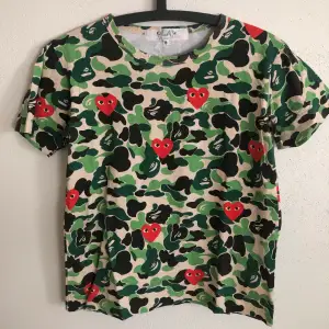 Women’s CDG Play / Comme Des Garçons x Bape T-Shirt  Size small, women’s fit.  Great condition, no flaws or damage.  DM if you need exact size measurements.   Buyer pays for all shipping costs. All items sent with tracking number.   No swaps, no trades, no offers. 