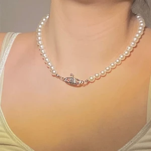 Halsband - Vitt pärlhalsband med smycke i mitten. Helt oanvänt. Man kan både ha det lösare och tajtare än vad jag har på bilden. Säljer för 50kr+ frakt 