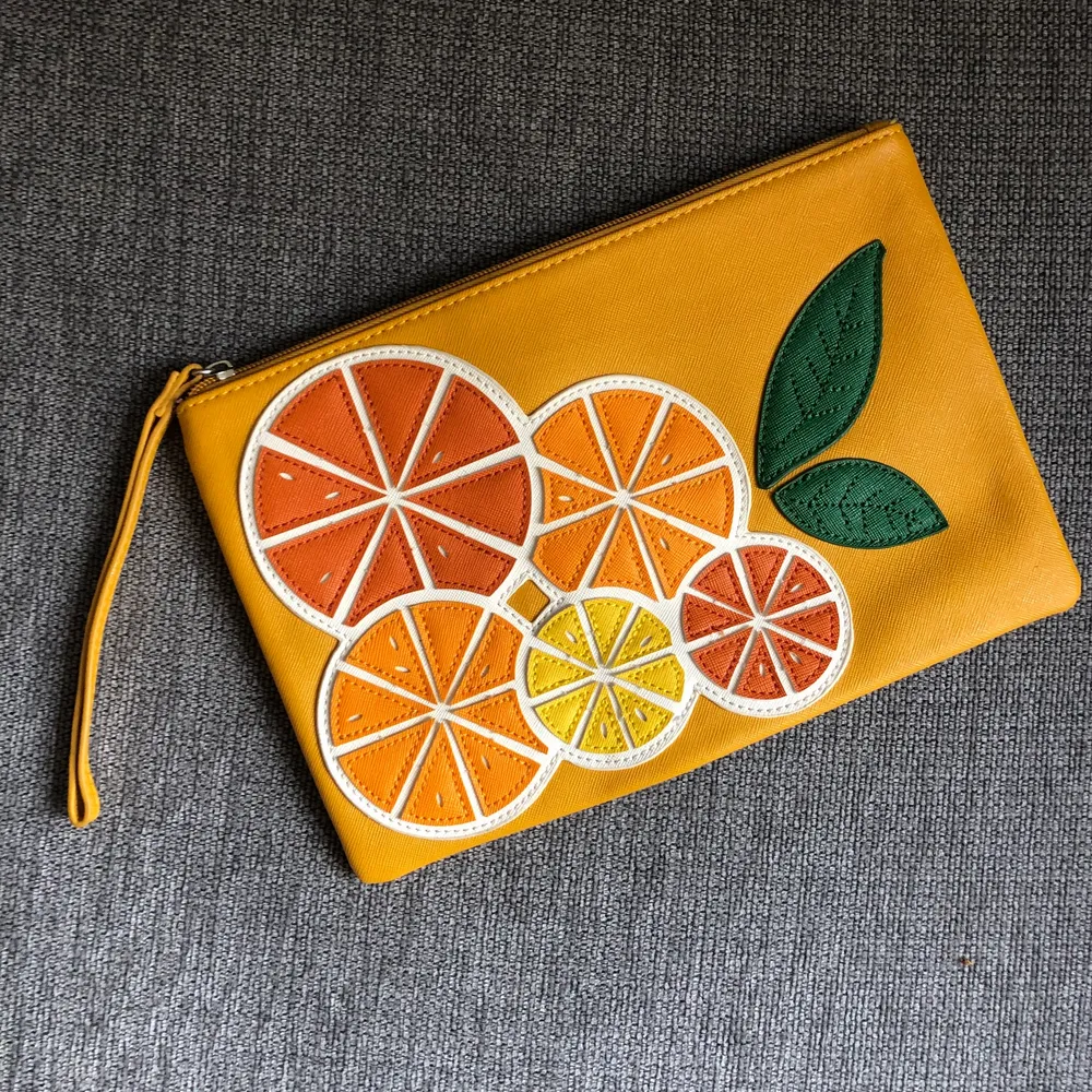 Orange clutch with tasty orange decoration from Mango. Make your outfit special! . Väskor.