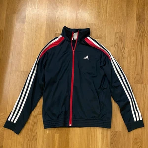 Adidas zip up tröja - Denna tröja är i storlek 152 (barnstorlek) men sitter som en xs eller s. Den är använd ett fåtal gånger och är i super bra skick utan noppor. Inuti är det ett tunt flis material och utanpå ett lite mer glansigt material. Vid intresse är det bara att höra av sig!