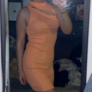 Aprikos tajt klänning med en splitt  - Klänningen har används ett fåtal gånger, riktigt fin sommarklänning har en fin splitt lite över bröstet 