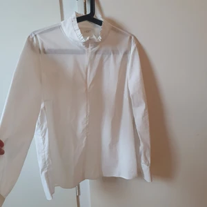 Skjorta Just Female - Söt vit skjorta/blus i mycket bra skick! Krage med lite krus i kanten, snygg volang över ryggen. Passform rak/ lite A-formad