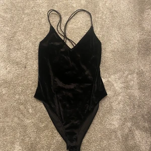 Body med öppen rygg - Svart body i sammet med öppen rygg.  köparen står för frakten 