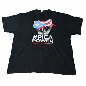 PicaPower - Vintage Graphic T-shirt - En riktigt fin svart tröja som ett stort grafiskt tryck från den kända löparen Pica. Har lite utav ett feministiskt motiv samt att trycket i sig är väldigt coolt. Har lite av en baggy fit. Köpt på en secondhandbutik i USA som heter Ross.