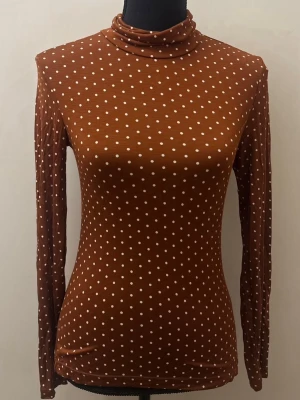 Prickig brun långärmad  - Strechigt material. Inget märke finns. Storlek S/M. 