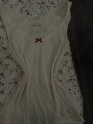 Vitt Odd Molly linne spets och rosett  - Storlek: 1 (motsvarar xs-s)  Färg: Vit  Märke: Odd Molly  Utseende: Linne i skönt och tunt material med spets som följer urringningen med en rosett på   Mycket fint! Kommer ej till användning  