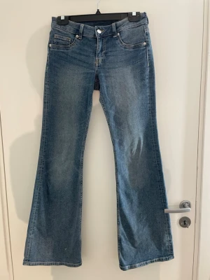 Blå bootcut jeans - Snygga blå bootcut jeans i klassisk tvätt med mellanmidja och fem fickor. Jeansen har vida ben och tydliga sömmar, perfekta för en avslappnad och trendig look. Tillverkade i denim med en lätt stretch för extra komfort. Pris kan diskuteras!!💕💕