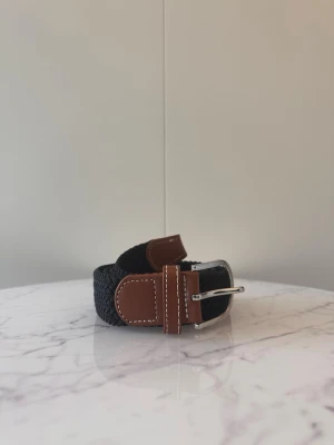 Svart flätat bälte - Tja säljer helt nya svenska klassiska flätade bälten från Bältgallerian i storlek 105cm lång och 3,5cm bred. Dem är i ett elastiskt material och finns i flera olika färger i min profil
