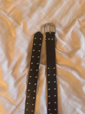 Svart nit skärp från BikBok - Snyggt svart skärp från BikBok med silverfärgade nitar längs hela bandet. Hör av er vid funderingar!🖤